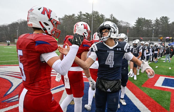 Framingham senior captain Matheus Silva slaps hands with Natick senior James Perrier at the conclusion of the annual Thanksgiving Day football game at Memorial Field in Natick, Thursday, Nov. 28, 2024. Natick High School defeated Framingham High School 42-15.