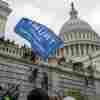 Supporters of President Donald Trump climb the West wall of the the U.S. Capitol, Jan. 6, 2021, in Washington.