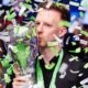 Judd Trump celebrates with the UK Snooker Championship trophy for the second time