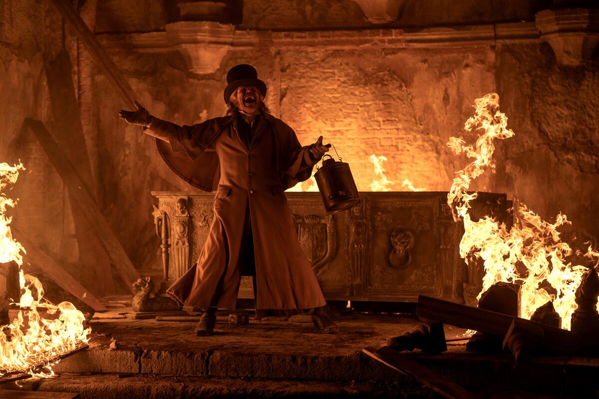 A man shouts in a burning crypt.