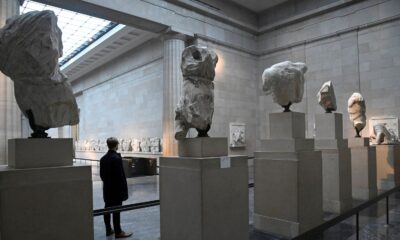 An employee poses as he views examples of the Parthenon sculptures, sometimes referred to in the UK as the Elgin Marbles, on display at the British Museum in London, Britain, January 25, 2023. REUTERS/Toby Melville