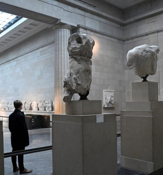 An employee poses as he views examples of the Parthenon sculptures, sometimes referred to in the UK as the Elgin Marbles, on display at the British Museum in London, Britain, January 25, 2023. REUTERS/Toby Melville