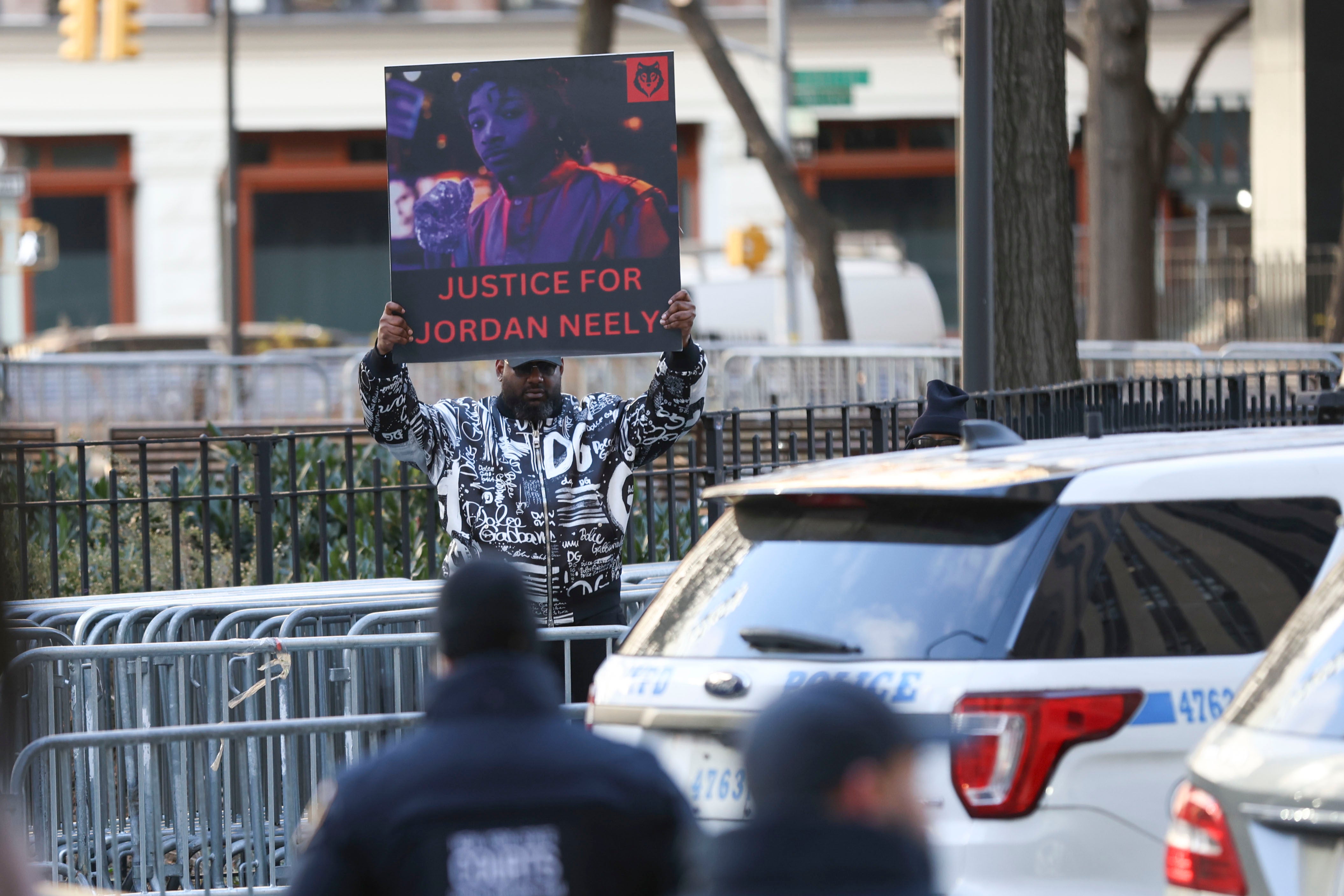 A protestor outside of court holds up a ‘Justice for Jordan Neely’ sign