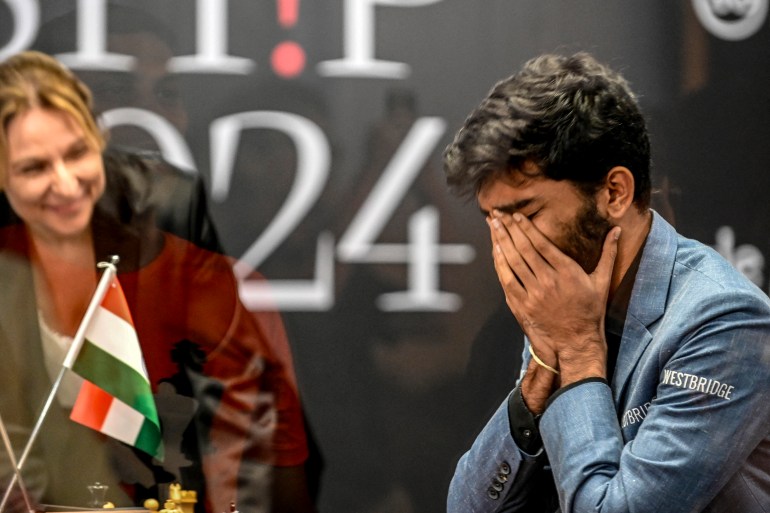 India's grandmaster Gukesh Dommaraju (R) reacts after winning against China's chess grandmaster Ding Liren in game 14 of the 2024 FIDE World Championship in Singapore on December 12, 2024.