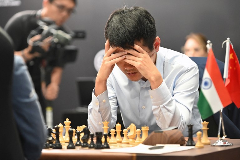 China's chess grandmaster Ding Liren competes against India's grandmaster Gukesh Dommaraju during game 14 of the 2024 FIDE World Championship in Singapore on December 12, 2024.