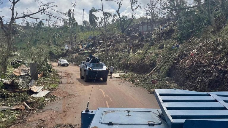 Gendarmes drive through a trail of destruction. Pic: AP