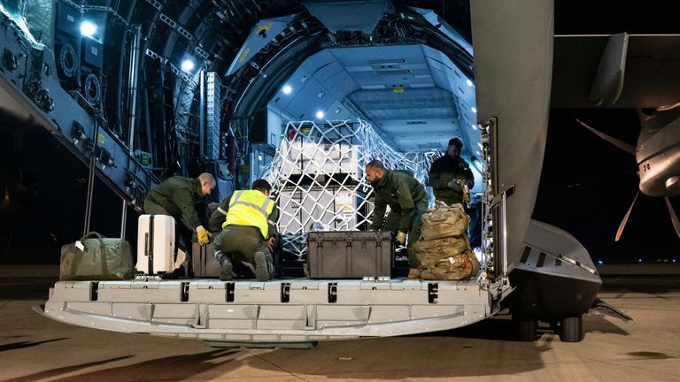 This photo provided Sunday Dec.15, 2024 by the French Army shows soldiers loading relief for the island of Mayotte, in the Indian Ocean, after Cyclone Chido caused extensive damage with reports of several fatalities, Saturday Dec.14, 2024 in Orleans, central France. (Laure-Anne Maucorps/ Etat Major des Arm..es via AP)