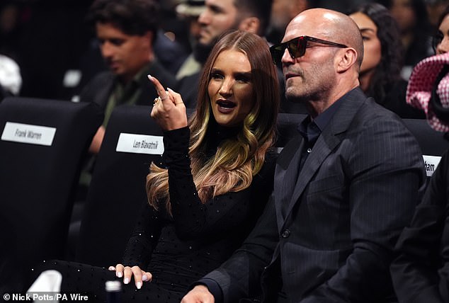 The blonde beauty appeared engrossed by the match as she sat ringside with her fiancé, 57, who looked incredibly dapper in a blue pinstripe suit