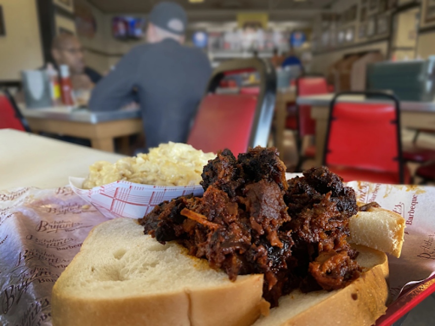 A paper-lined red basket with Arthur Bryant's barbecue meat and thick cut toast.