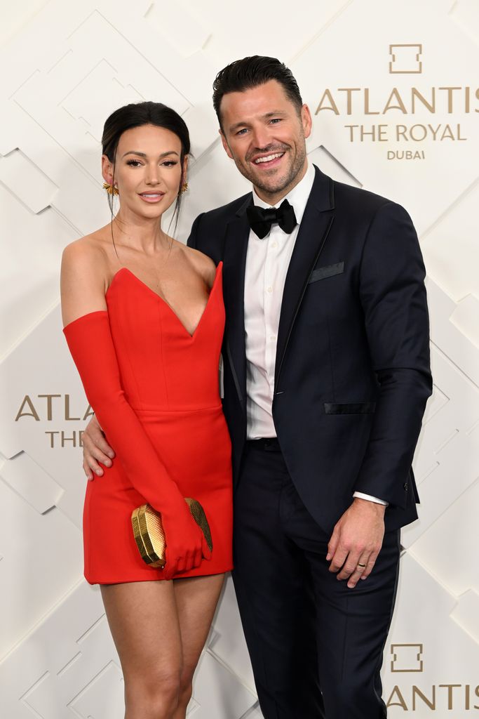 Michelle keegan in red strapless dress with mark wright in tuxedo at Atlantis The Royal Grand Reveal Weekend 2023