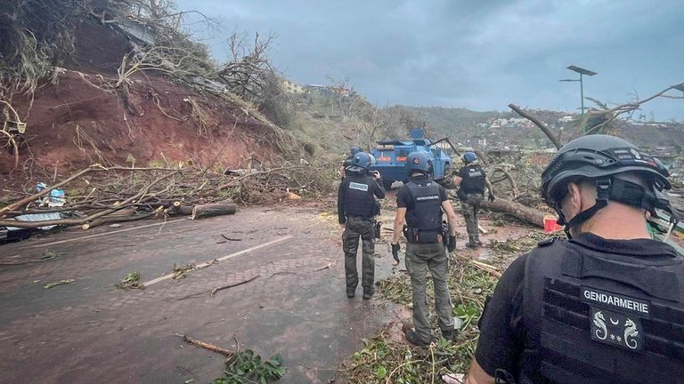 Gendarmes are seen clearing a road in Mayotte. Pic: AP