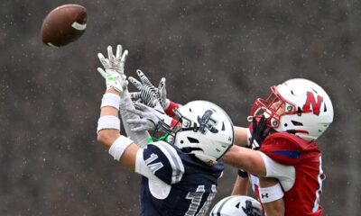 Framingham junior Kolven McBrayer makes an interceptoin on a pass intended for Natick senior Simon Pedrelli during the annual Thanksgiving Day football game at Memorial Field in Natick, Thursday, Nov. 28, 2024. Natick High School defeated Framingham High School 42-15.