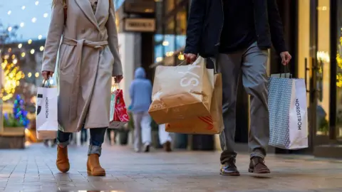 Getty Images Shoppers carry Macy's and Nordstrom bags at Broadway Plaza in Walnut Creek, California, US, on Monday, Dec. 16, 2024