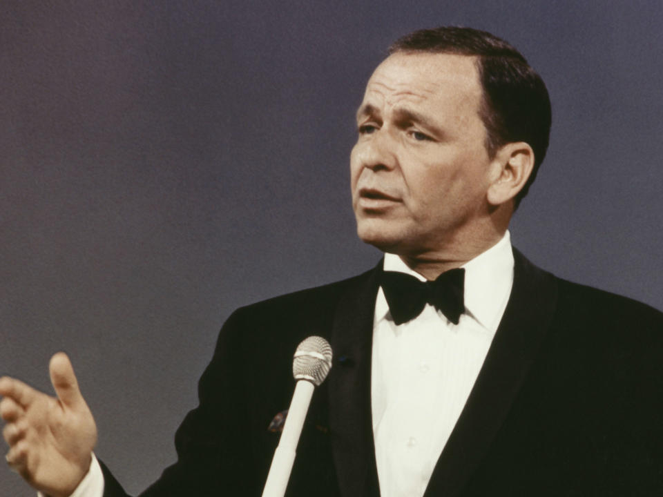 Frank Sinatra performs on stage wearing black tuxedo circa 1965. (Photo by Screen Archives/Getty Images)