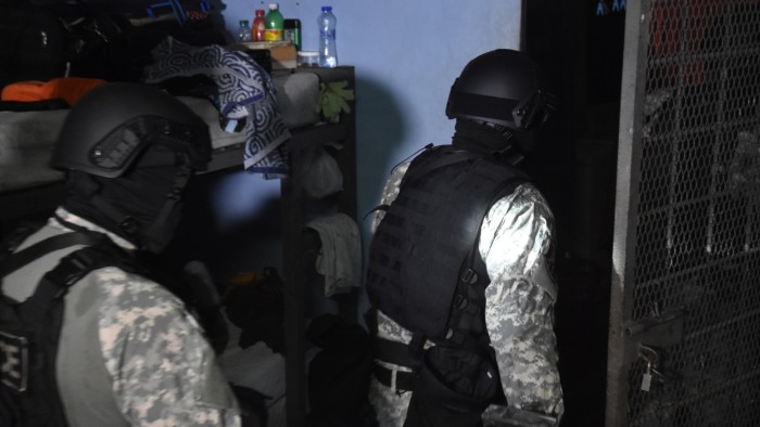 Police officers entering a building