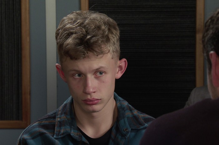 Dylan is petrified as he sits in a chequered shirt