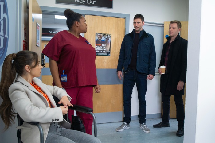 Daisy and a nurse loom at Kit and Daniel at the hospital in Coronation Street