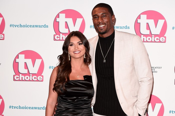 India Reynolds and Ovie Soko standing together and smiling