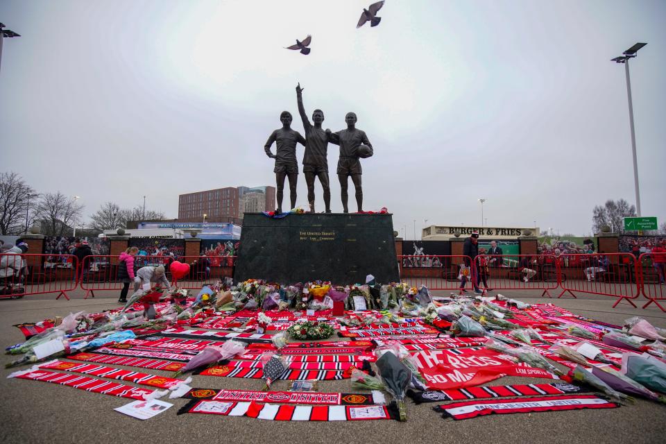 A statue of Manchester United trio of George Best, left, Denis Law, center, and Sir Bobby Charlton (AP)