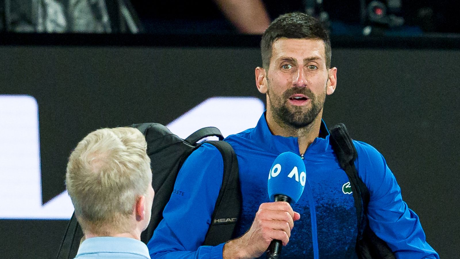 Novak Djokovic of Serbia speaks to the crowd following victory against Jiri Lehecka of the Czech Republic in the Men's Singles Fourth Round match during day eight of the 2025 Australian Open at Melbourne Park on January 19, 2025 in Melbourne, Australia. (Photo by Andy Cheung/Getty Images)