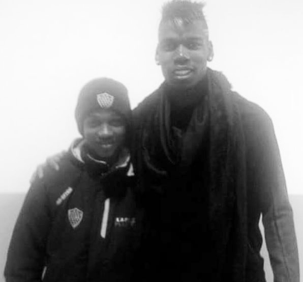 Black and white photo of Paul Pogba and Amad Diallo.