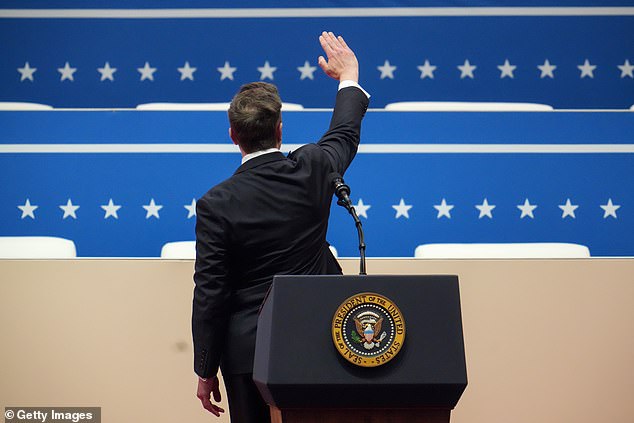 Musk turned and made the same 'awkward hand gesture' to the crowd behind him