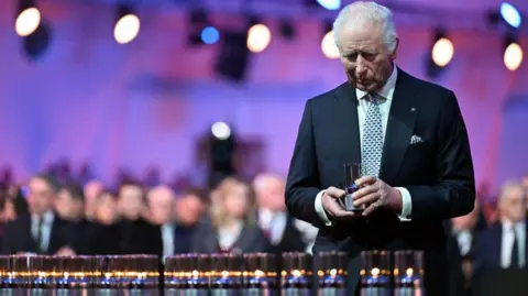 Getty Images King Charles pays tribute to the victims during commemorations on the 80th anniversary of the liberation of the German Nazi concentration.