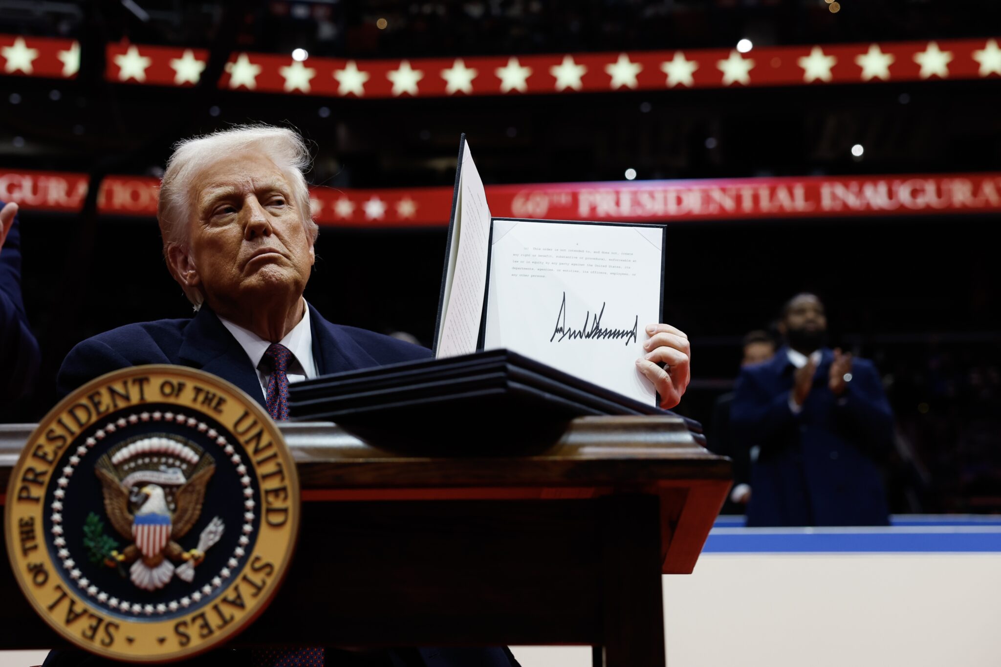 President Donald Trump holds up an executive order after signing it during an indoor inauguration parade at the Capital One Arena on Jan. 20, 2025, in Washington, D.C. (Photo by Anna Moneymaker/Getty Images)