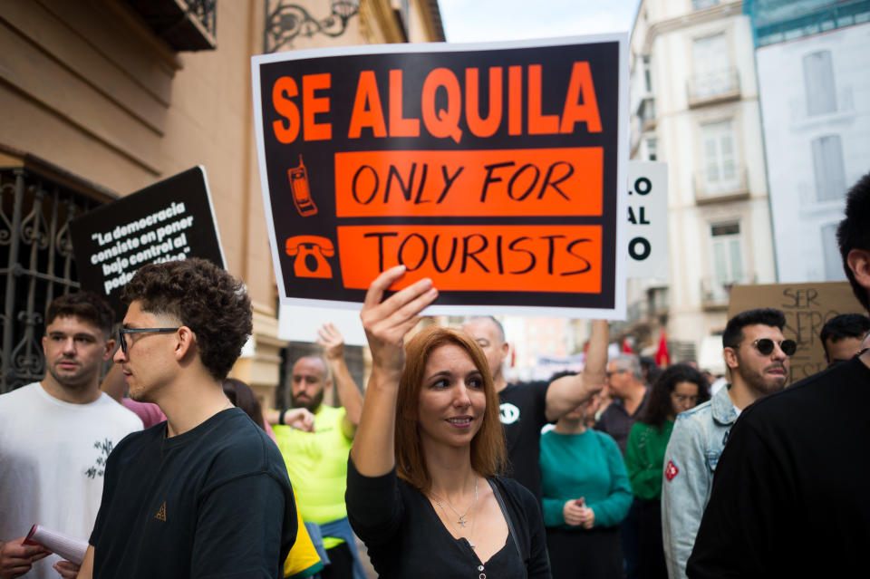 MALAGA, SPAIN - 2024/11/09: A woman is seen holding a placard as she takes part in a demonstration against mass tourism in the city and demanding a decent housing. Thousands of people took to the streets in the centre of Malaga to protest against rising rental prices. Over the past few years, the city has experienced a significant housing crisis, largely due to rent speculation and a process of gentrification, which has made it difficult for many to access a decent rental housing system. Local neighbourhood associations and organisations are calling for measures to be introduced to limit rental prices and the impact of mass tourism. (Photo by Jesus Merida/SOPA Images/LightRocket via Getty Images)