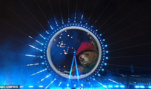 A huge show of fireworks lit up Big Ben in spite of storm warnings that forced many displays to be axed today, with many fans left stunned by a 'world-first' Paddington Bear cameo