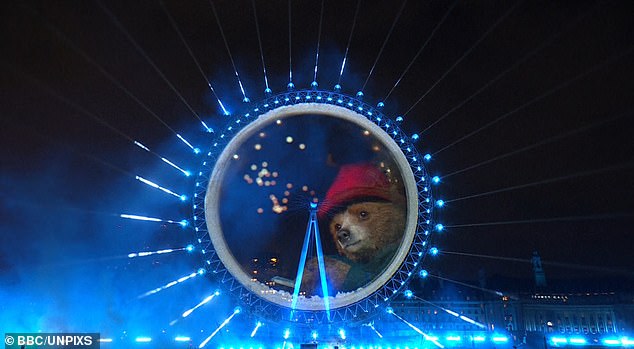 A huge show of fireworks lit up Big Ben in spite of storm warnings that forced many displays to be axed today, with many fans left stunned by a 'world-first' Paddington Bear cameo