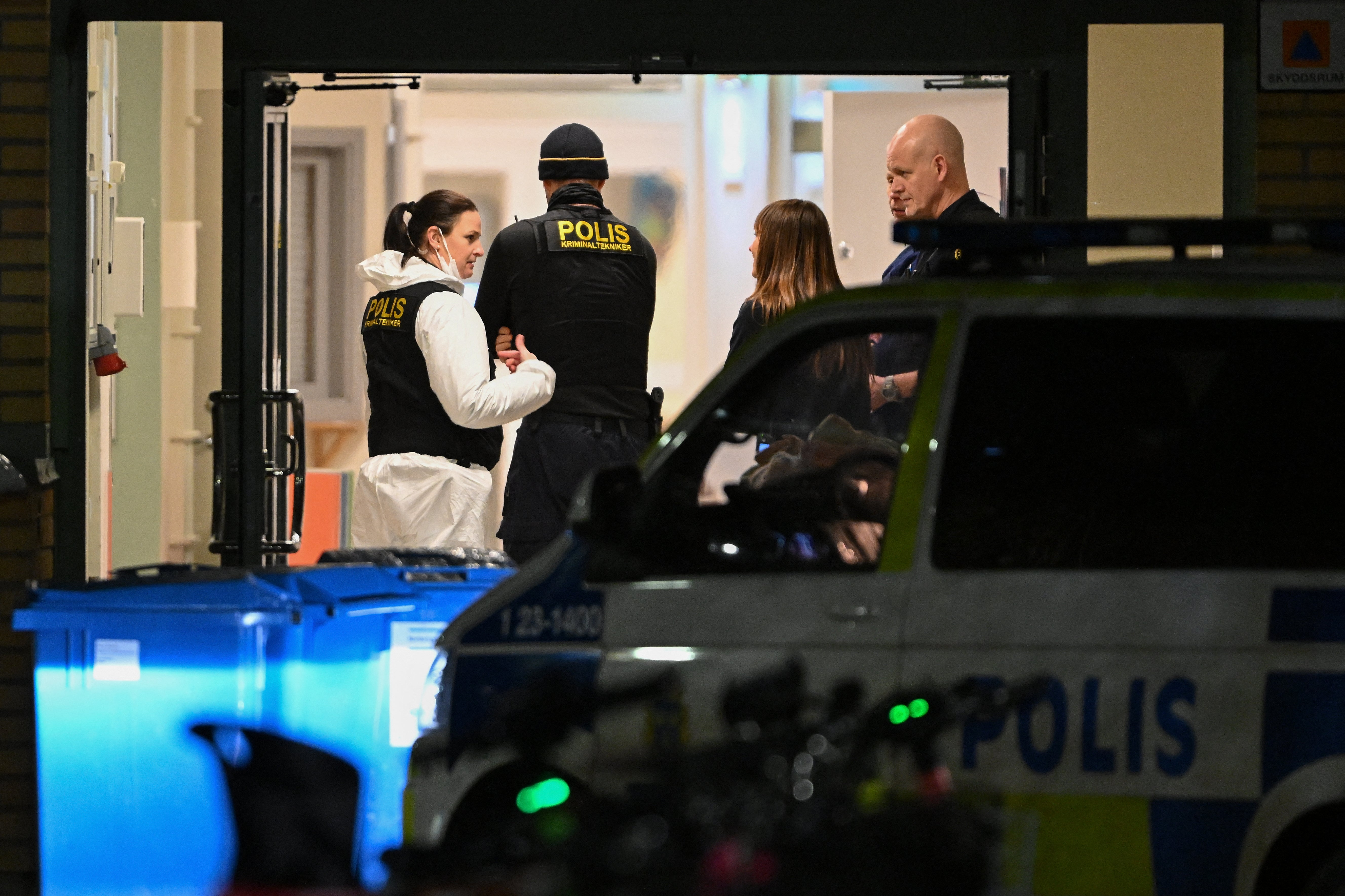 Forensic police officers work at the scene of the Risbergska School